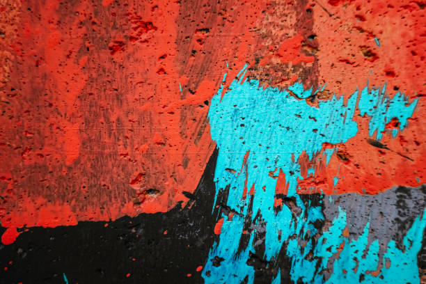 istock Abstract painted wall background. Messy paint strokes and smudges, light blue color drips, flows, streaks on grunge orange and black wall background 2187028233