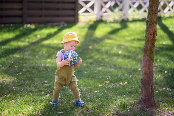 Toddler Playing with a Ball in a Sunny Park