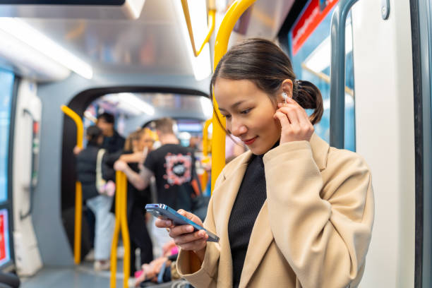 istock Asian woman using mobile phone on train. 2187031533