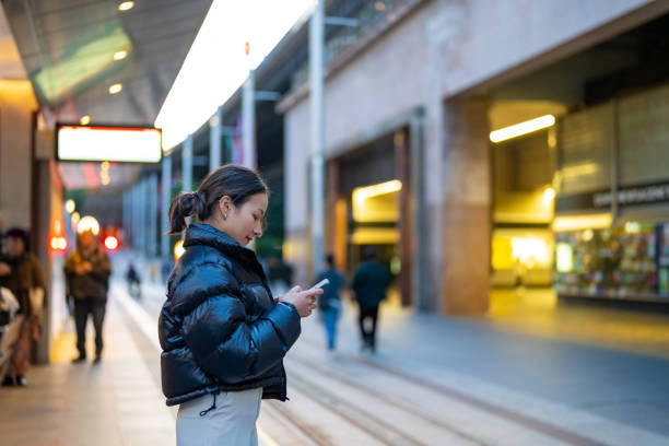 istock Asian woman using mobile phone in the city. 2187031575