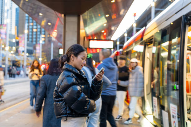 istock Asian woman using mobile phone in the city. 2187031579
