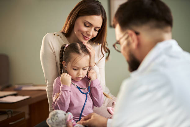 istock Small girl and doctor using stethoscope on stuffed toy 2187032242