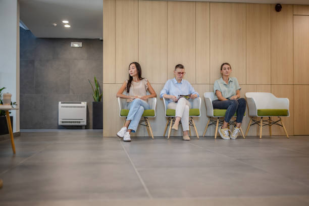 istock Individuals seated quietly in a modern polyclinic corner. 2187035279