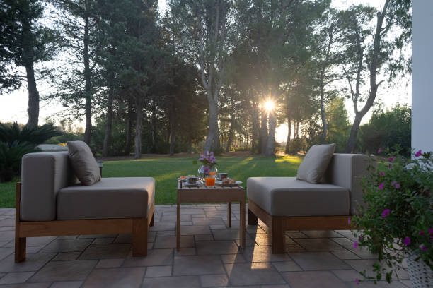 Outdoor Seating Area with Evening Sunlight and Green Background