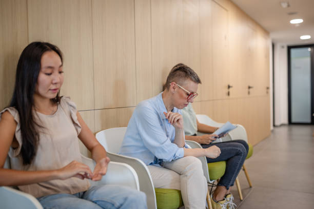 istock People waiting in clinic with focus on documents 2187037967