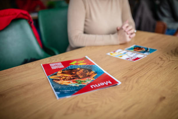 istock Close-up view of menu placed on a wooden cafe table. 2187043075