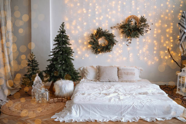 istock Cozy winter bedroom decor with lights and festive greenery in an inviting space 2187045458