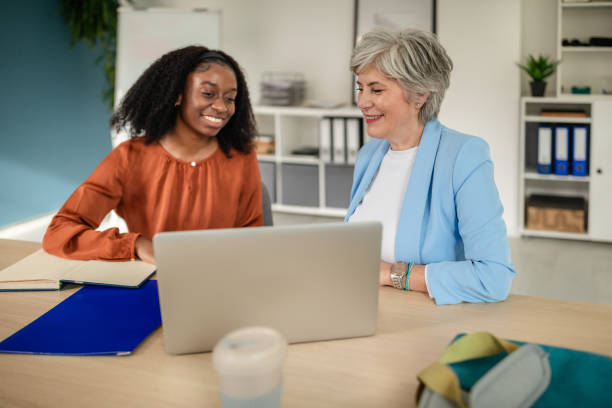 istock Two women discussing work at a laptop in office 2187047197