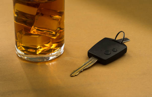 istock Alcohol glass and a car key on table. 2187047250