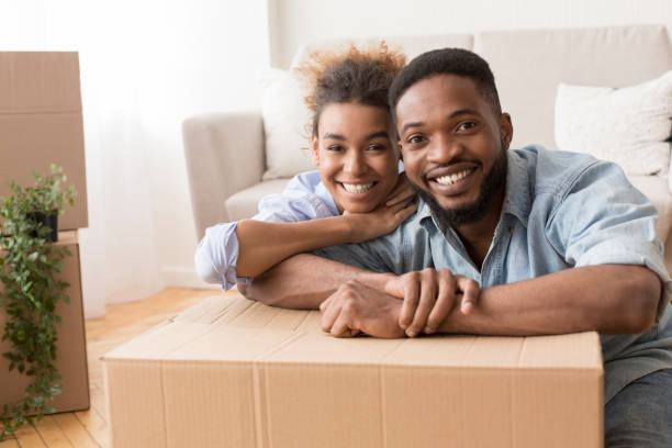 istock Spouses Embracing Among Moving Boxes Sitting In New House 2187051372