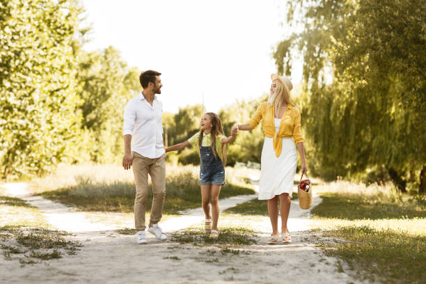 istock Happy parents resting with child in countryside 2187053780