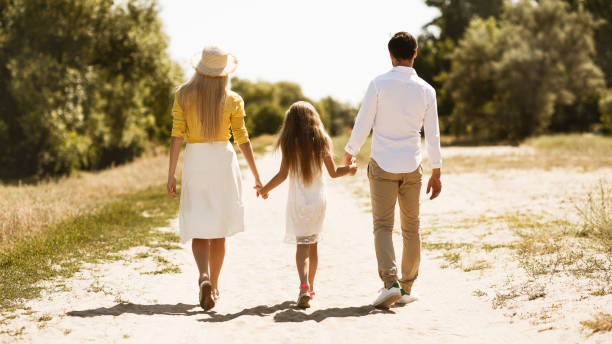 istock Parents and little girl walking in countryside 2187055152