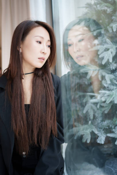 istock Woman looking at herself on the glass 2187056141