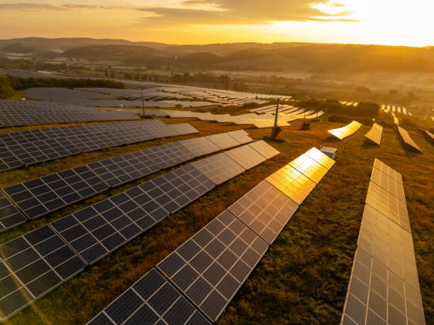 istock Agricultural Field Hosting Solar Panel Installation at Sunrise 2187060028