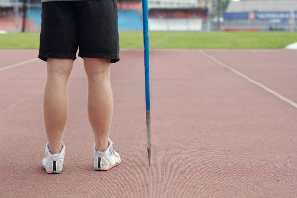 Low Angle View Of Male Athlete High Jumping Against Sky