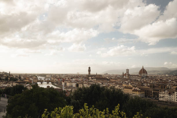 This stunning view of Florence captures the heart of the city, with its iconic Duomo towering above the terracotta rooftops. The clear sky and soft lighting highlight the rich architectural details of the city, offering a breathtaking perspective of Florence’s timeless beauty. In the distance, the hills provide a tranquil backdrop to the bustling city below.