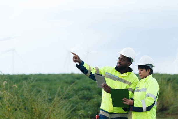 istock Electricians having a conversation and discussion at electric generator windmill station. 2187066836