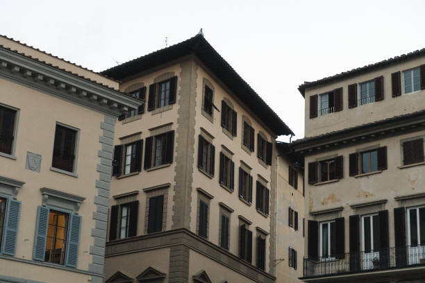 The elegant facades of Florence stand as a testament to the city’s timeless architecture. This photo captures a unique angle of the city’s buildings, their brown shutters and traditional stonework contrasting with the soft, cloudy sky above. The structures create a sense of both history and modernity, perfectly showcasing the harmonious blend of old and new that defines Florence. As the city’s charm emanates from every corner, the streets below buzz with quiet energy, inviting exploration and discovery.