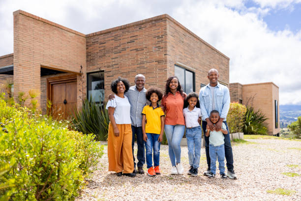 istock Three-generation family smiling outside their new home 2187069447