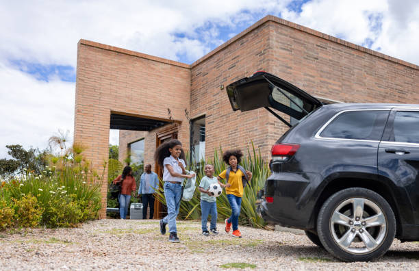 istock Happy kids loading things in the car while going on a road trip 2187069450