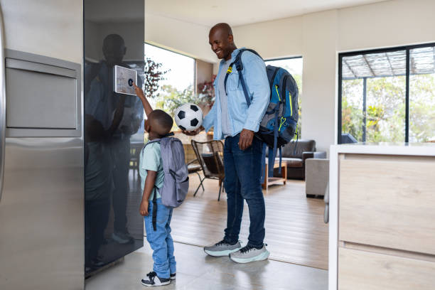 istock Father and son leaving their house and locking the door using an automation system 2187069460