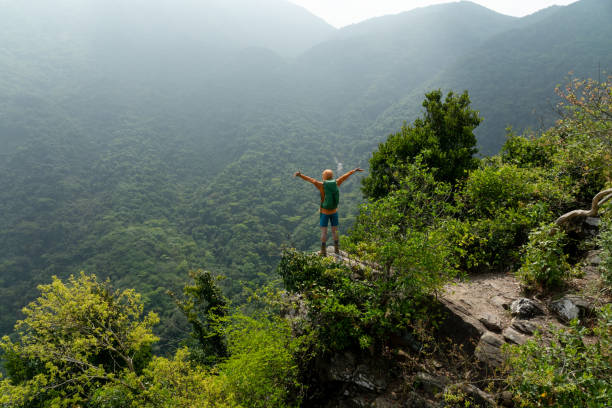 istock Young woman backpacker hiking at forest mountain top 2187069865