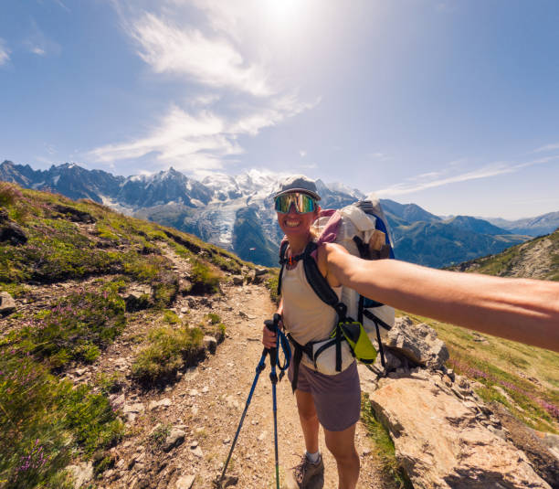 istock Adventurous Hiker Takes Selfie on Mountain Trail Under Clear Sky 2187071418