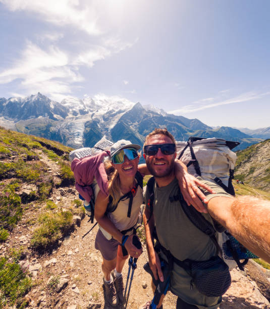 istock Couple Hiking on Mountain Trail Smiling for a Selfie 2187071437