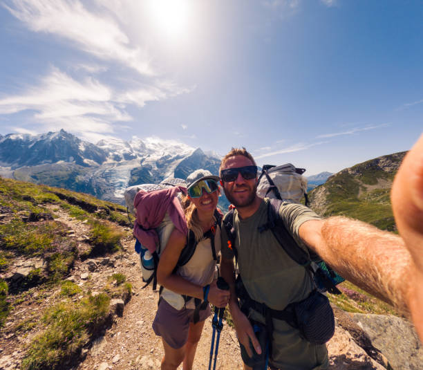istock Couple Hiking on Mountain Trail Smiling for a Selfie 2187071439