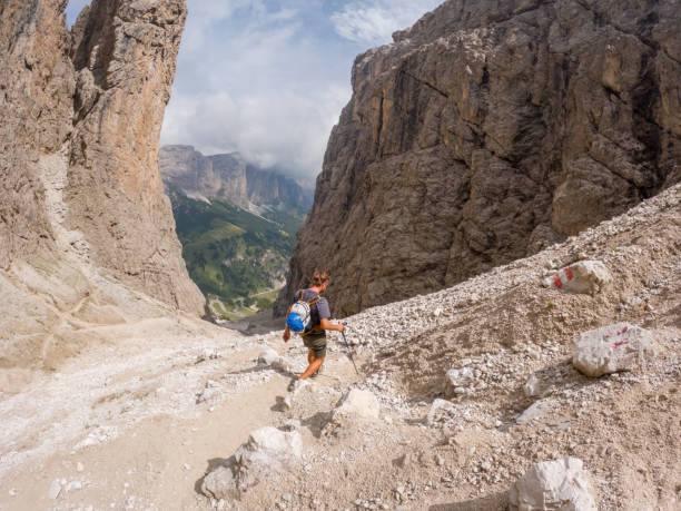 istock Hiker Enjoying Stunning Alpine Scenery with Rocky Paths and Mountain Peaks 2187073354