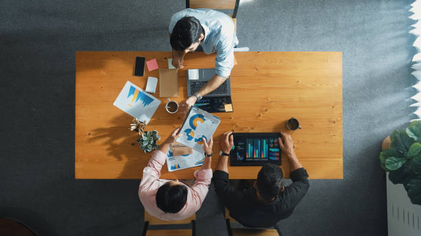 istock Top view of smart business people sharing idea and writing report. Convocation. 2187076138