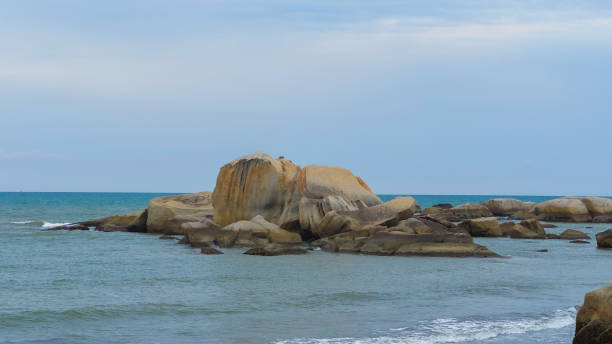 istock Vast Blue Sea Surrounding Big Brown Orange Boulder And Rocks 2187076805