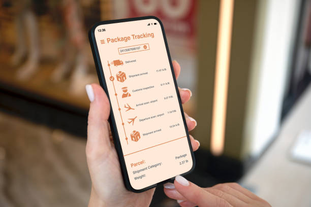 istock Female hands holding phone with app tracking delivery package screen 2187081436