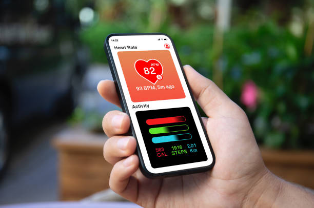 istock Man hand holding phone with app heart and activity screen 2187081450