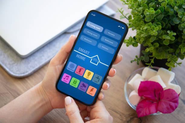 istock woman hand hold phone with application smart home on screen 2187081503