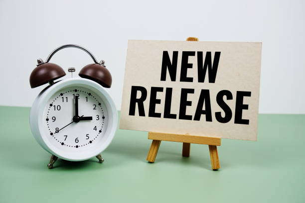 istock New Release text on paper card with alarm clock on green background 2187082504