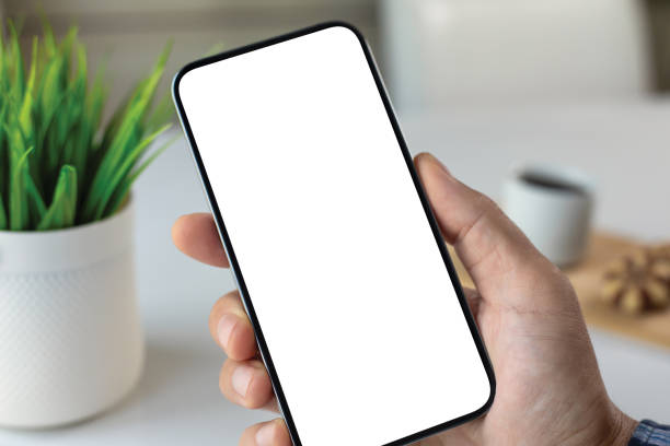 istock male hand holding phone with isolated screen background white office 2187084060