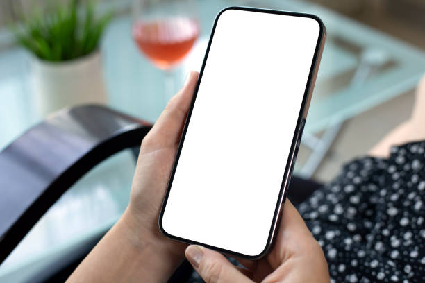 istock female hands holding phone with isolated screen background glass wine 2187084085