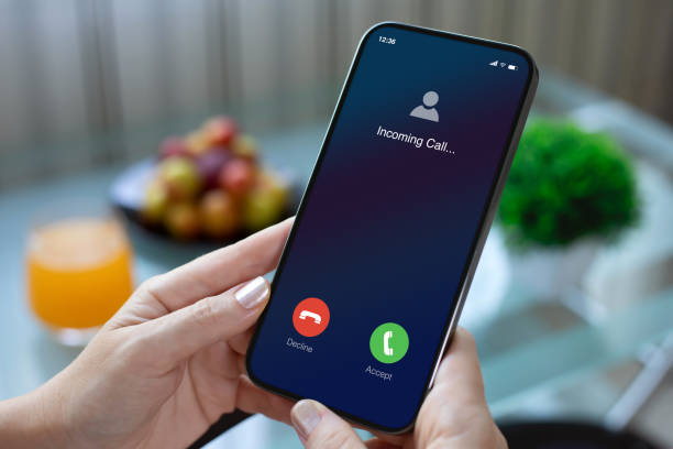 istock female hands holding phone with incoming call screen in cafe 2187084171