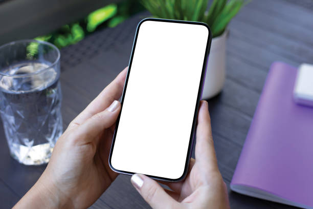 istock female hands holding phone with isolated screen background table cafe 2187084263