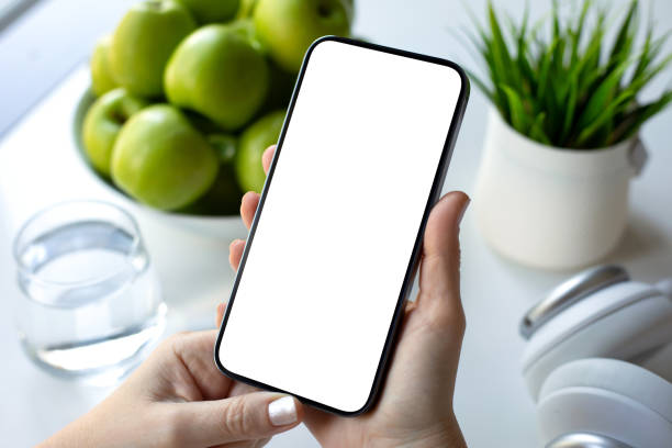 istock female hands hold phone with isolated screen background green apples 2187084358