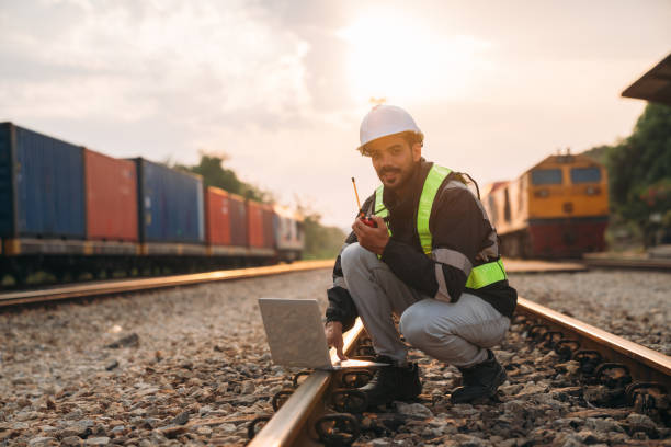 istock Foreman inspecting inventory or task details on freight train cars and shipping containers, highlighting logistics operations in the import and export industries. 2187085327
