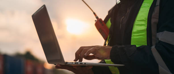 istock Foreman inspecting inventory or task details on freight train cars and shipping containers, highlighting logistics operations in the import and export industries. 2187085392