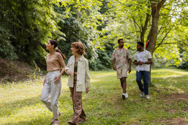 istock Friends walking and talking in a park during summer vacation 2187086282