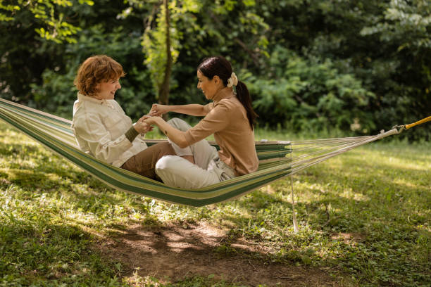 istock Friends enjoying summer vacation relaxing in hammock 2187086321