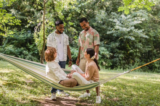 istock Happy multi ethnic friends enjoying summer vacation together in a hammock 2187086336