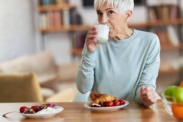 istock Senior woman drinking milk during breakfast at home. 2187086926
