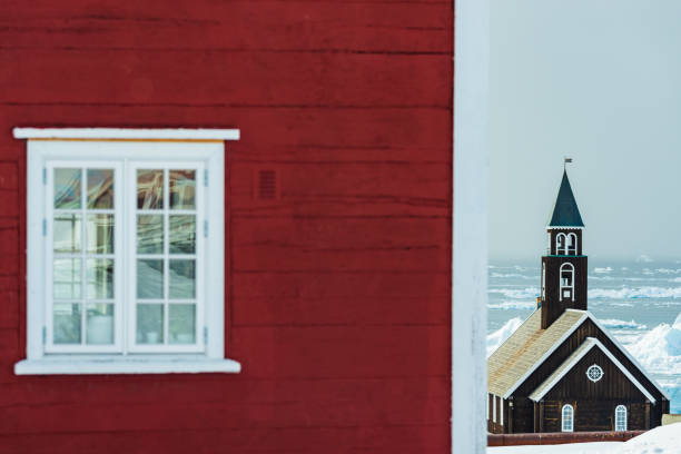 Red house in front of church