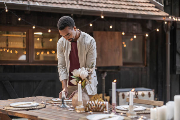 istock Man preparing table for a festive dinner party outdoors 2187087775