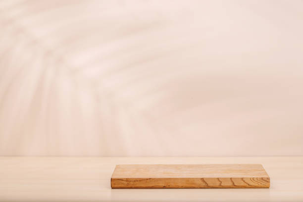 istock Template with board on table and wall with natural plant shadow and sunny glare 2187088325